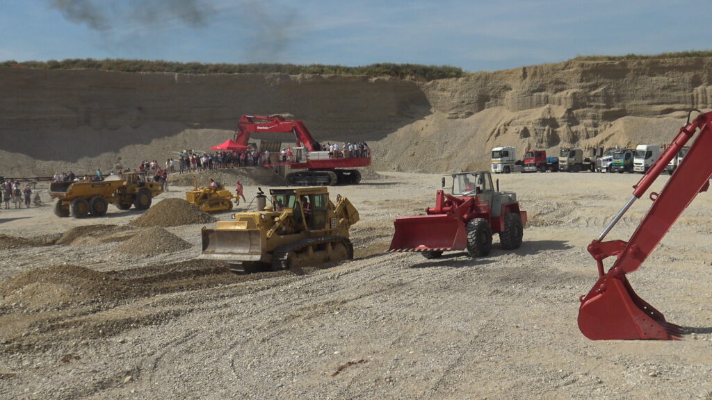 Poclain 1000 en arrière-plan et des bulldozers et autres bouteurs au premier plan
